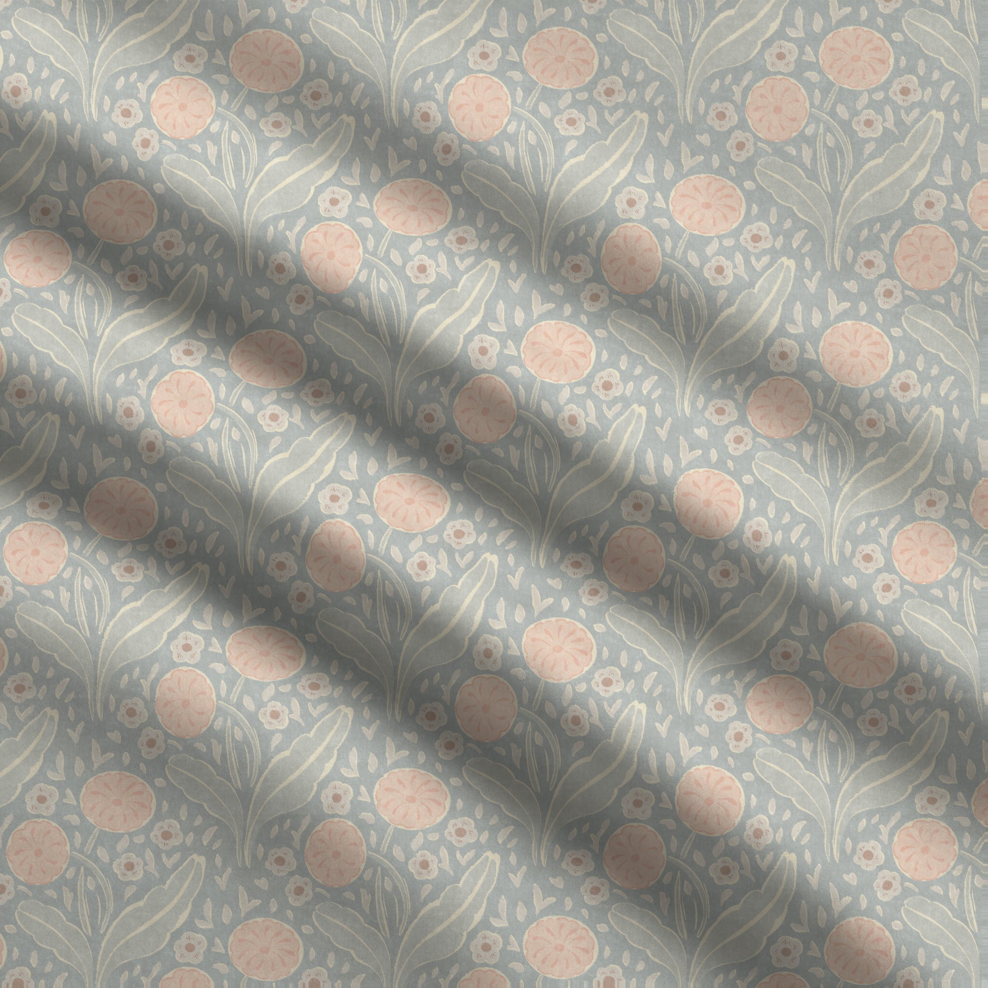 Floral patterned fabric with pink flowers and green leaves on a blue background