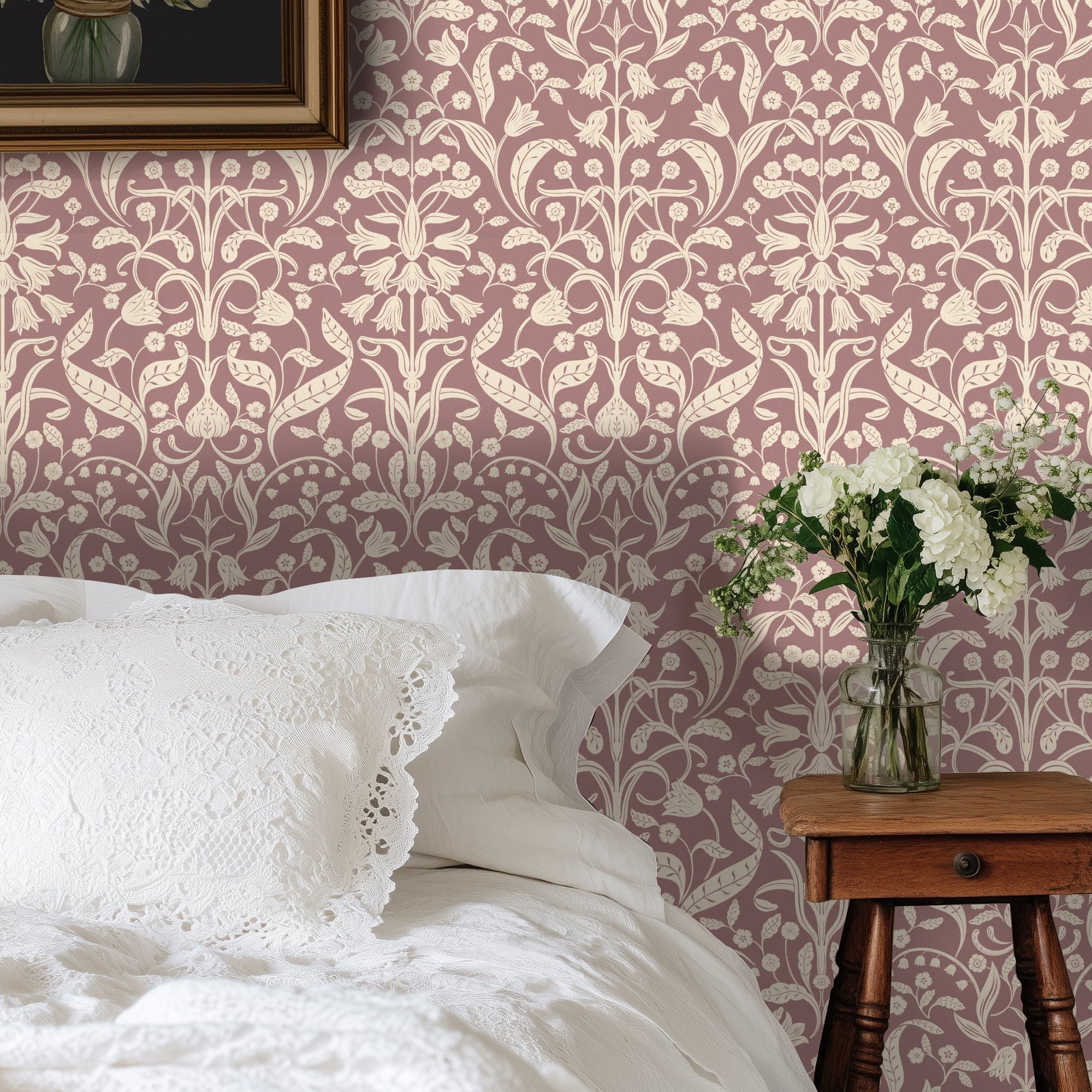 Bedroom with floral wallpaper, white bedding, and a wooden side table with flowers.