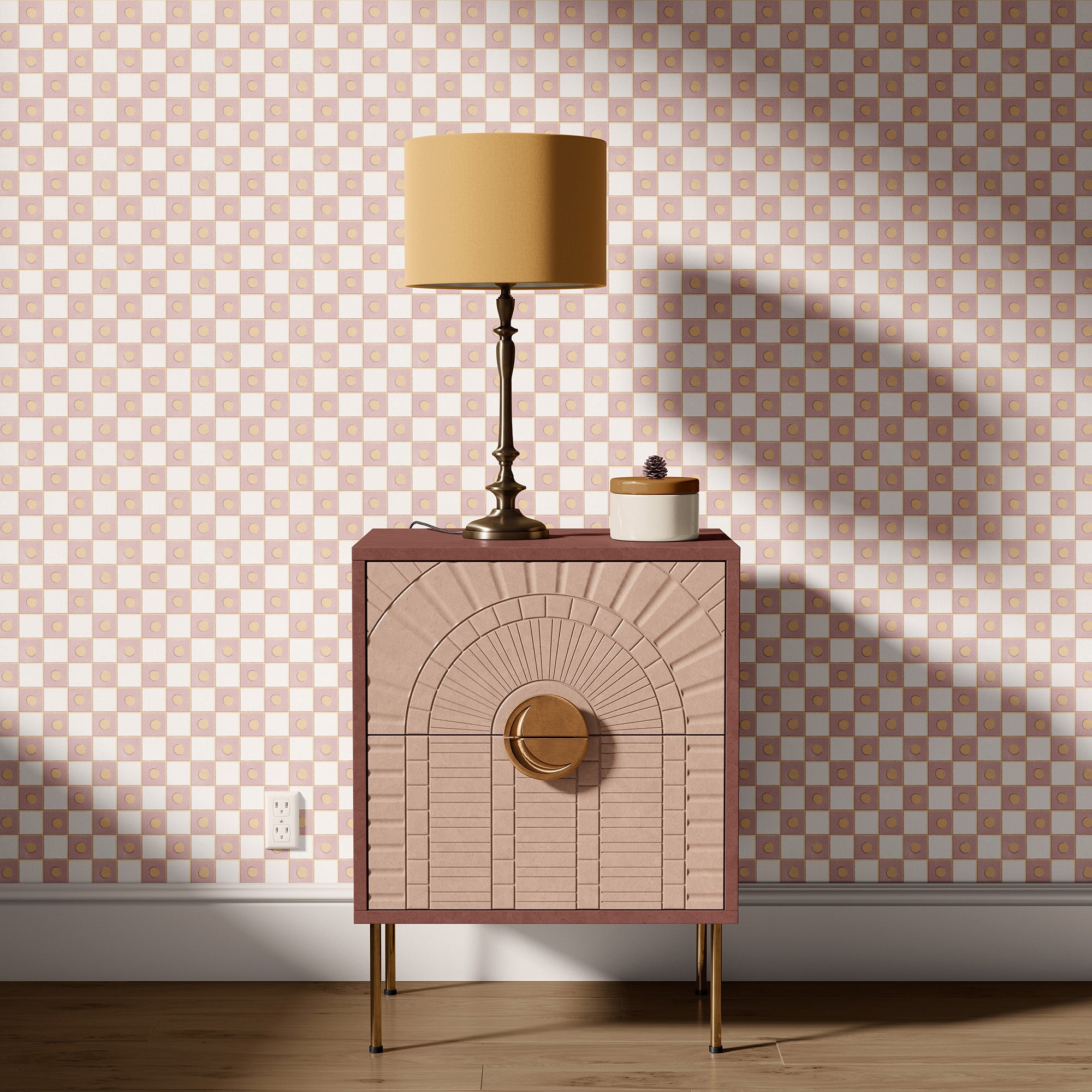 Pink side table with gold accents against a checkered wall