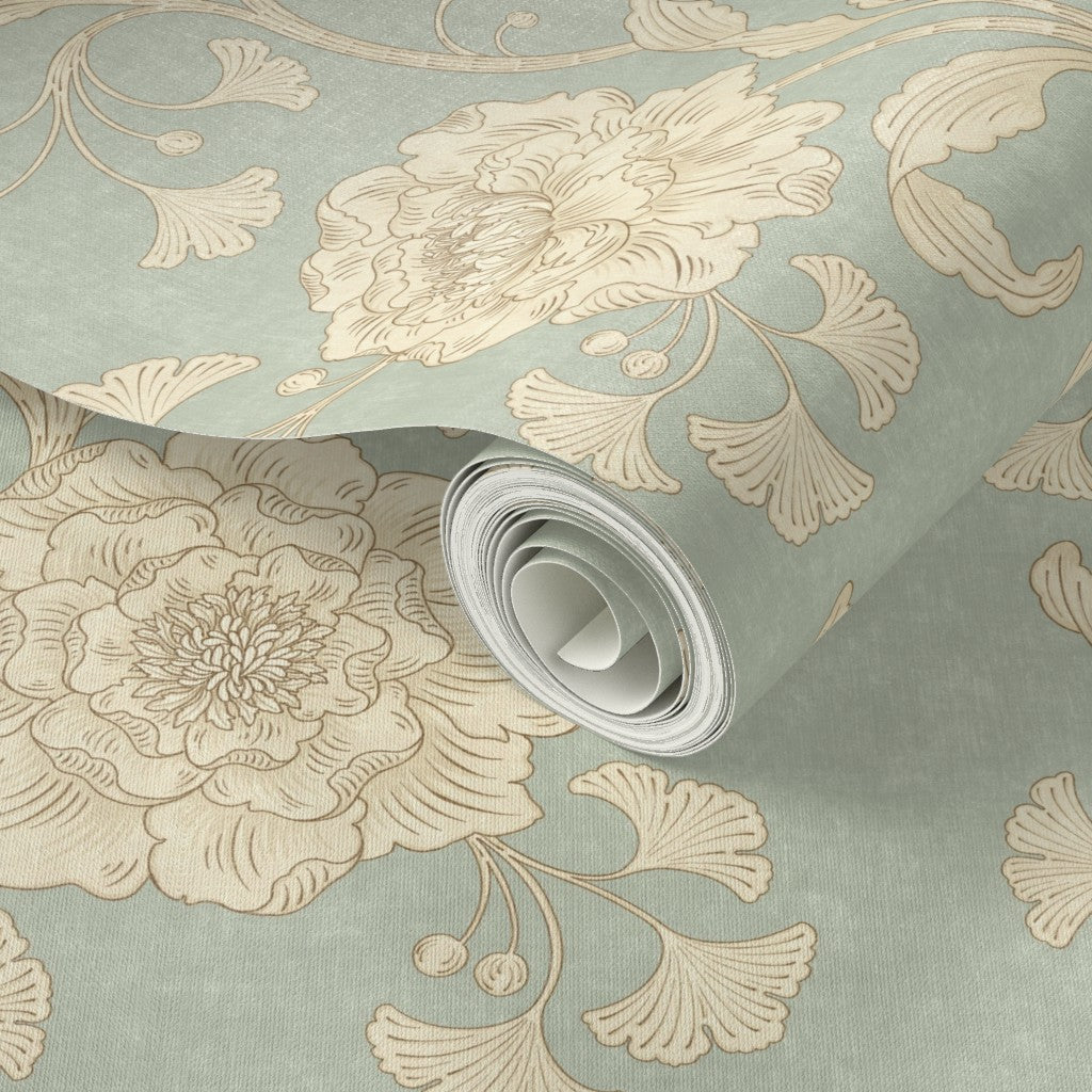 Roll of floral-patterned wallpaper with beige flowers on a light blue background