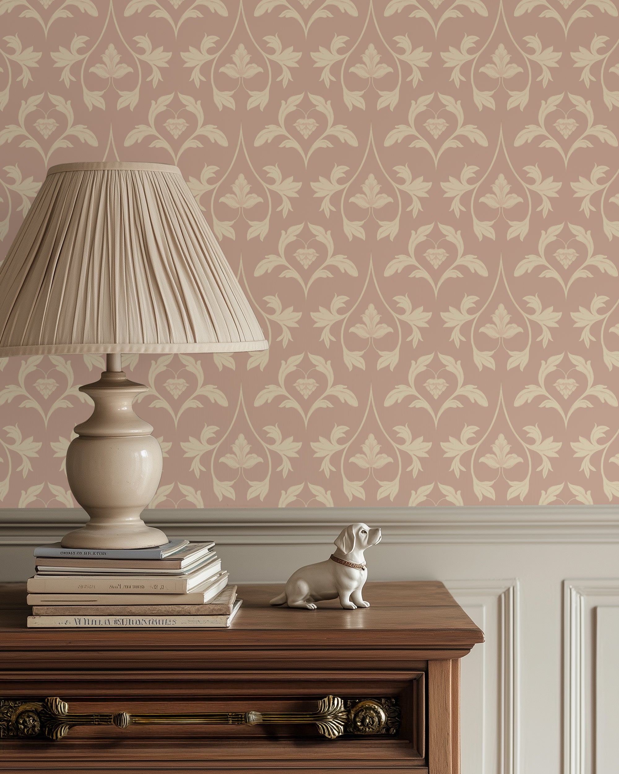 Decorative lamp on books with a small dog figurine against a patterned wallpaper background